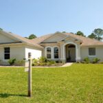 white and brown concrete bungalow under clear blue sky