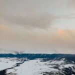 snow covered mountain under the cloudy sky