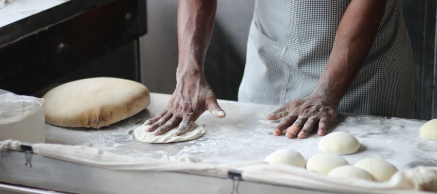 man preparing dough for bread