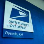 post office signage on concrete wall