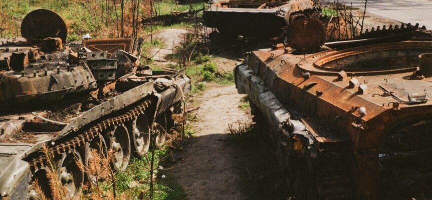 abandoned military vehicles on side of the road