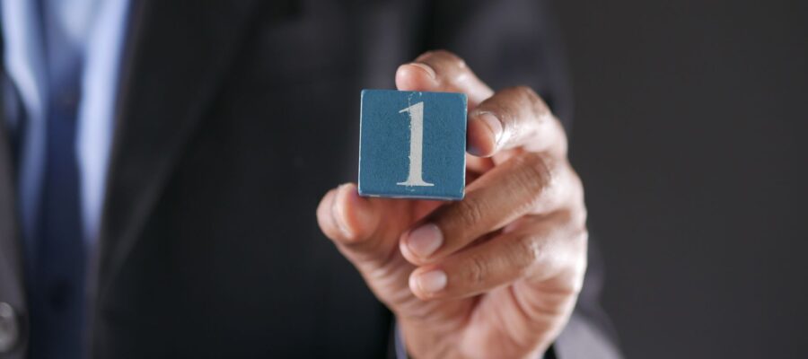 a close up shot of a person holding a block with a number
